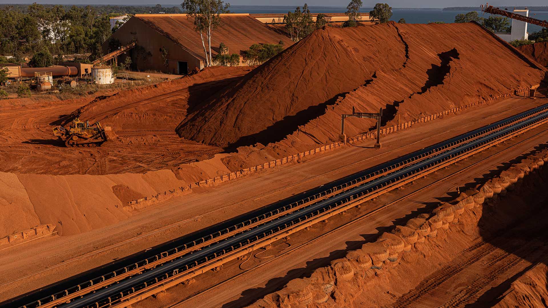 Bulldozer pushing bauxite onto stockpiles, Weipa Operations