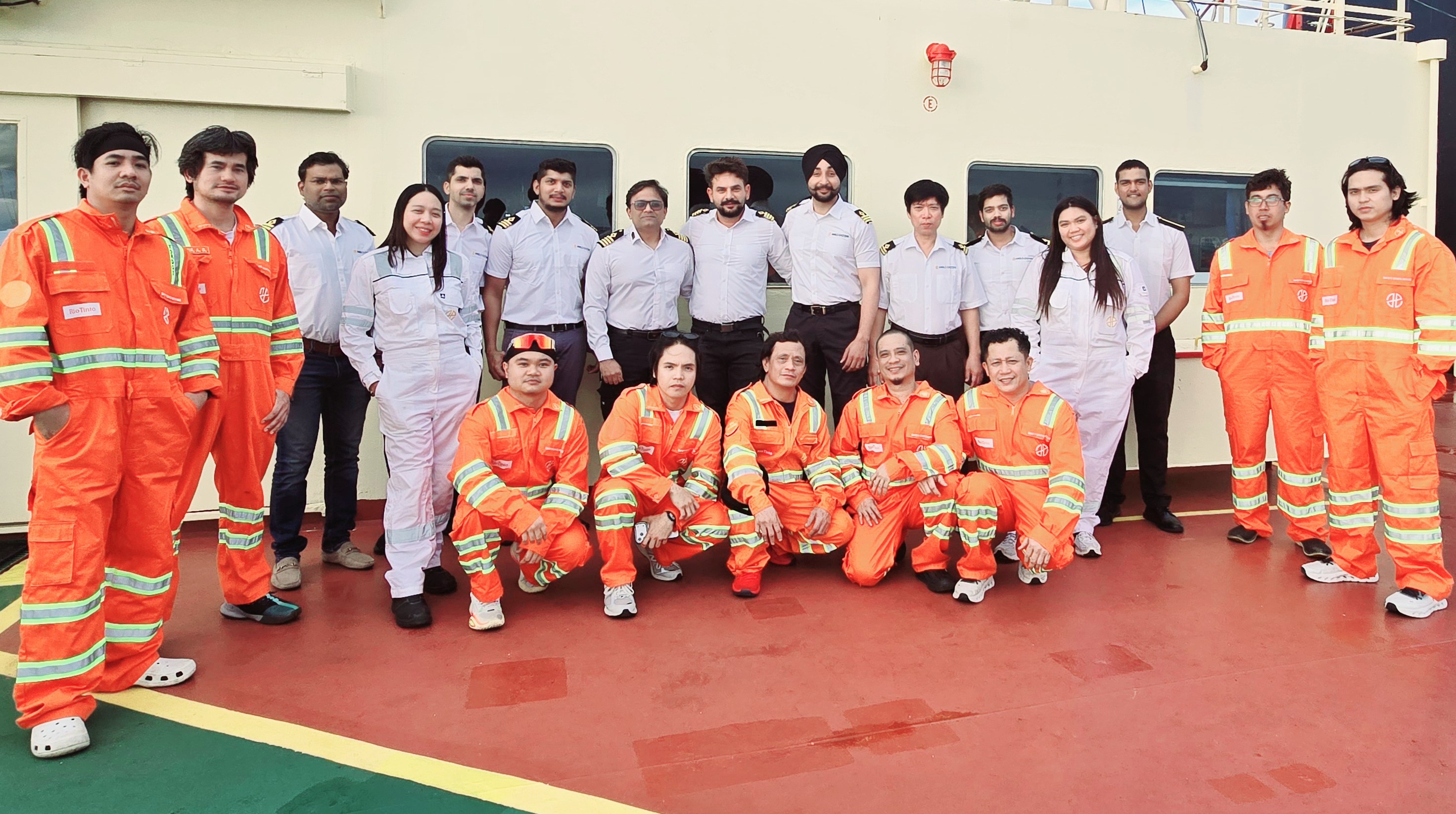 Group of seafarers wearing their work safety gears and posing for the camera.
