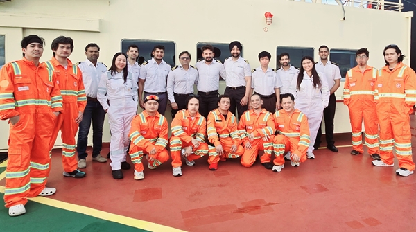 Group of seafarers wearing their work safety gears and posing for the camera.