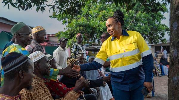 Fanta shaking hands with people at Beyla, a town neighbouring Simandou, at a town meeting.