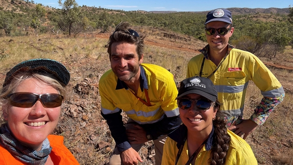 A group of Rio Tinto employees taking selfie on a mine site