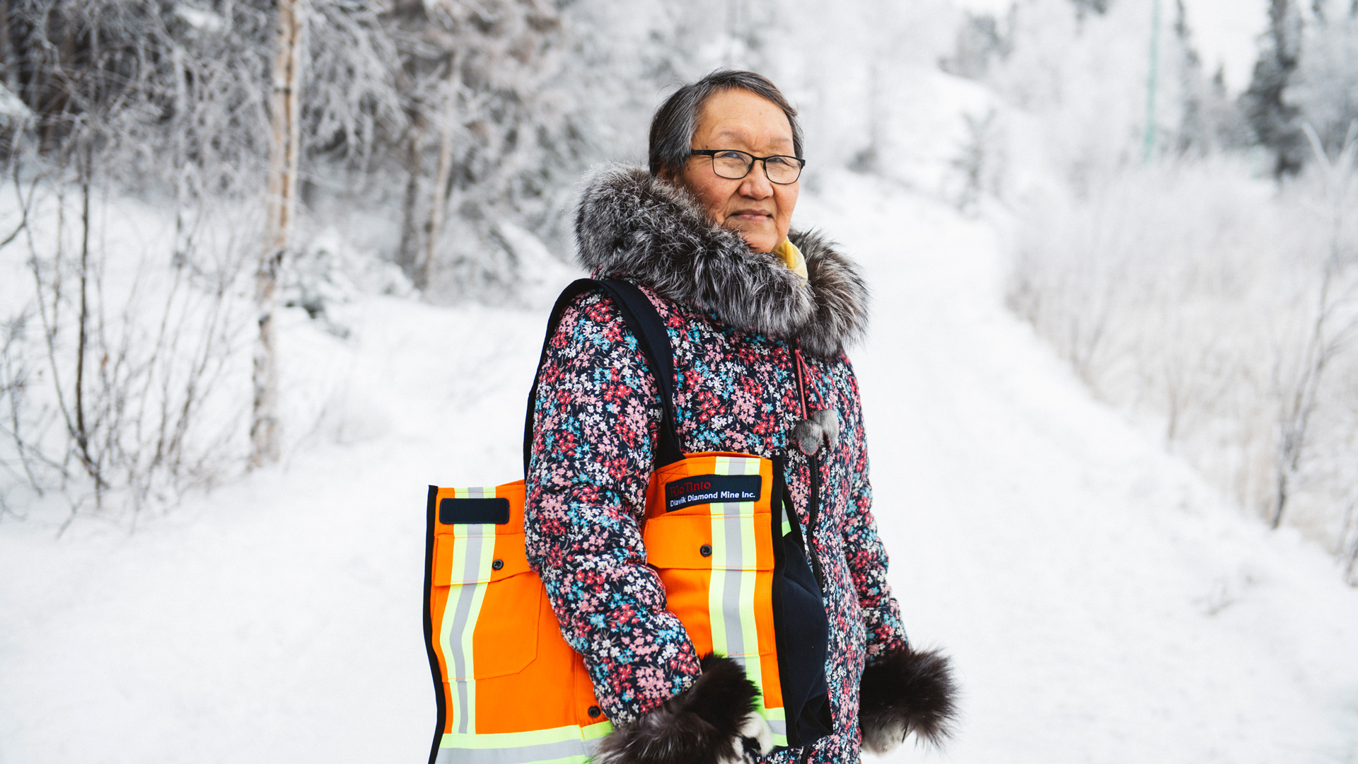Iga wearing accessories from ReMade and posing for camera in front of snowy hill background.
