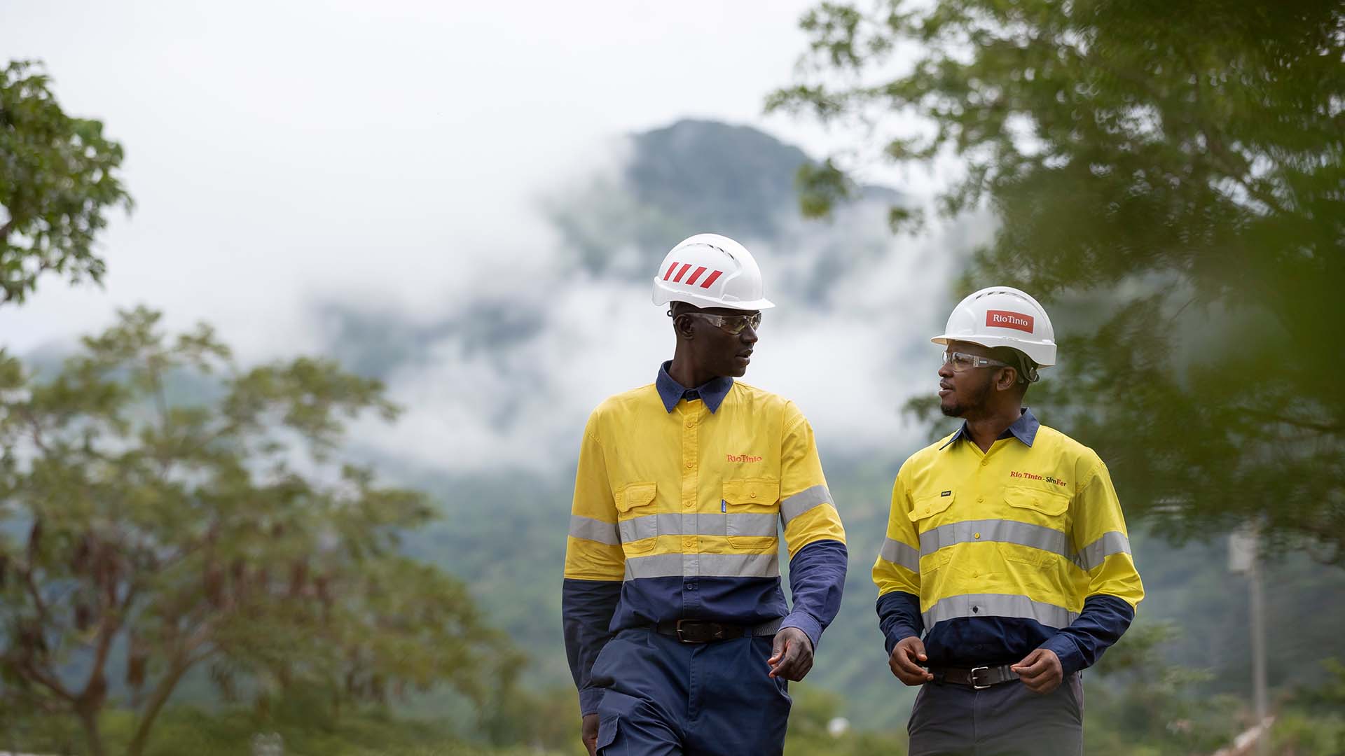 Employees at walking and talking at Canga East Camp along road to Pic de Fon, Simandou Guinea