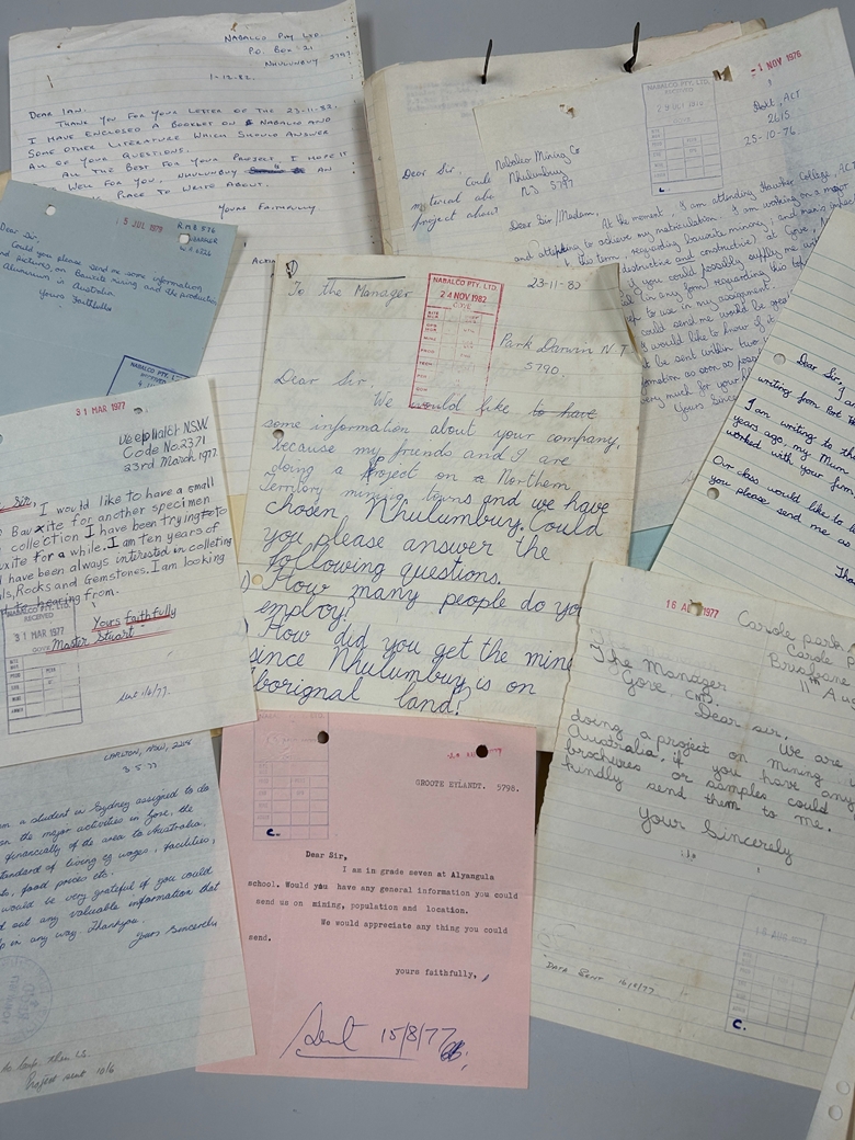 Collection of handwritten letters and typed notes arranged on a flat surface, many dated from the 1970s.