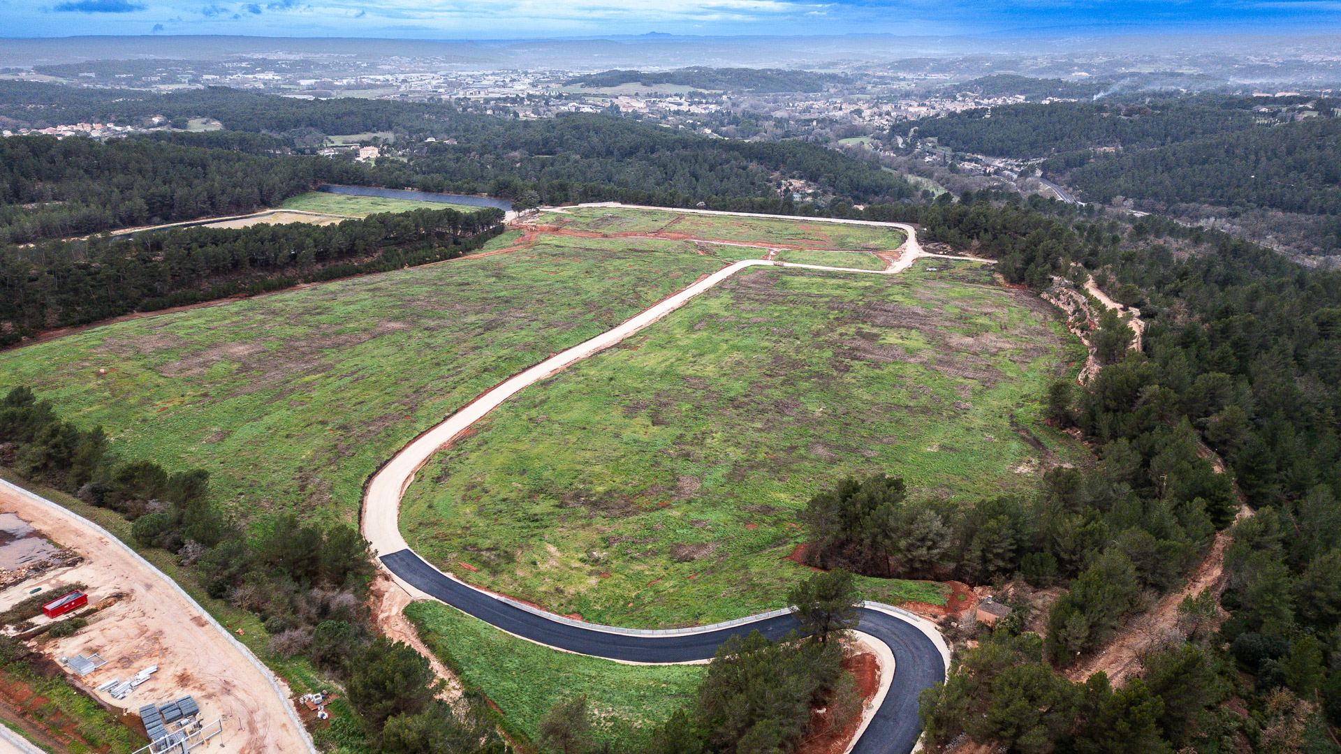 Aerial shot of an open land with a road at Mange Garri