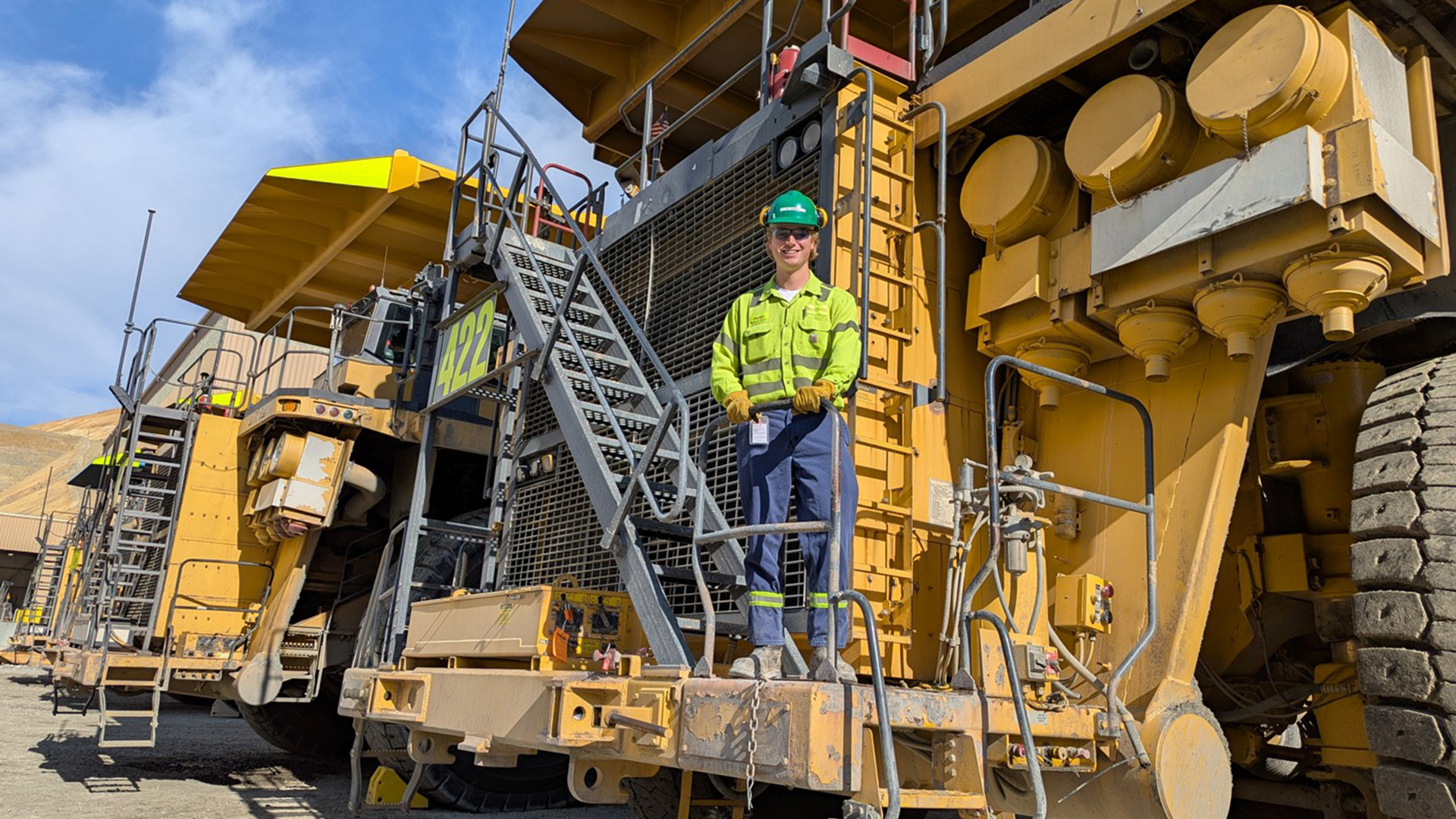 Pat in front of a haul truck