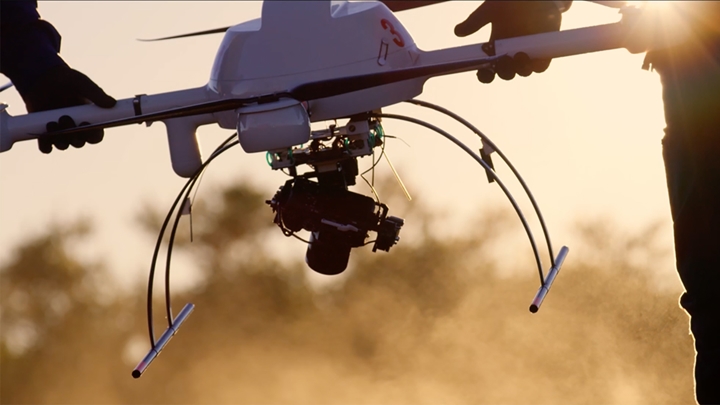 Employees carrying drone