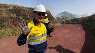 Bold has his hand up in Rio Tinto mining PPE at Simandou